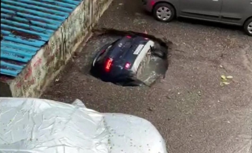 Car falls into sinkhole