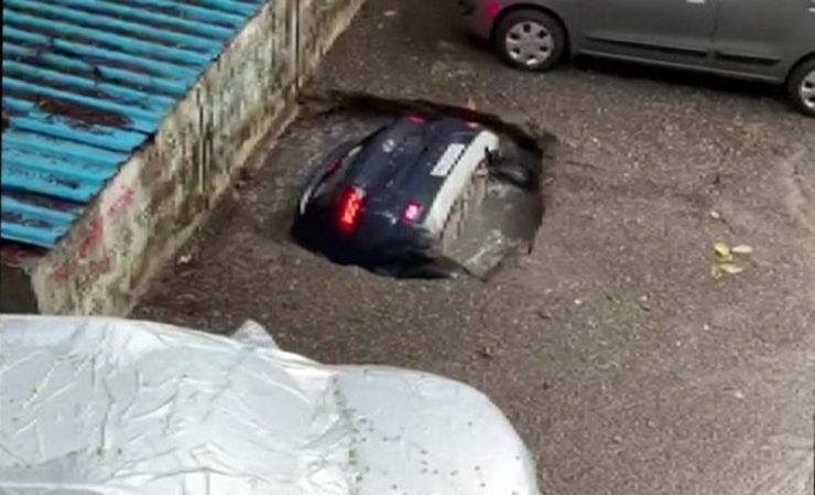 Car falls into sinkhole